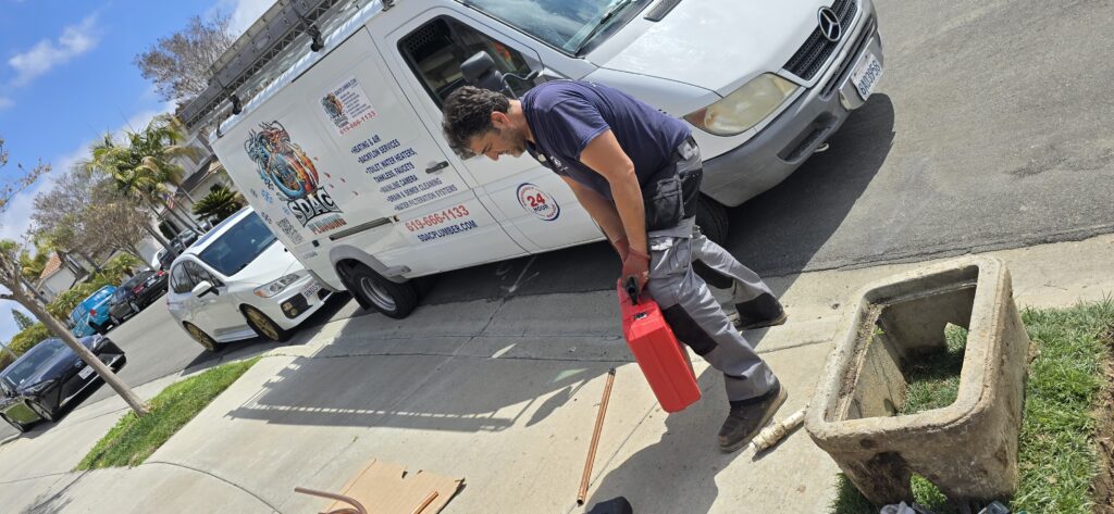 Emergency plumber responding to a residential water line repair with service truck on site.