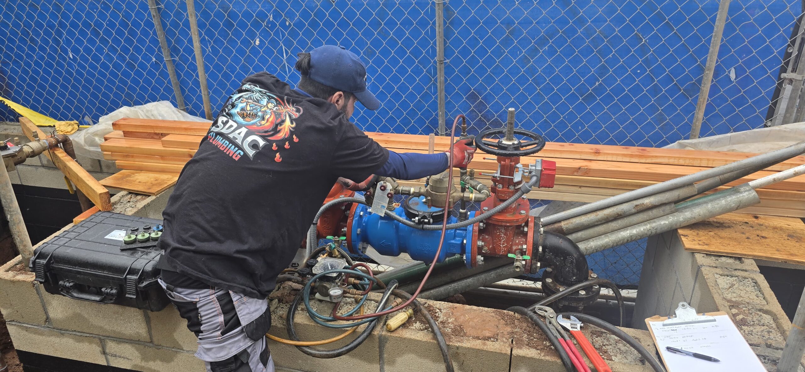 Backflow system inspection and repair in progress.